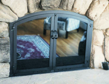 Nantucket Arch All black finish,  twin doors, smoked glass, and standard forged handles, visual draft panel. Comes with  gate mesh spark screens.  (Inside fit on stone)